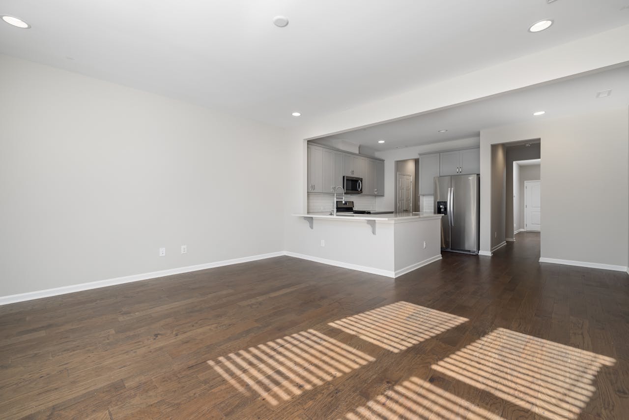 Crafting Captivating Headlines: Your awesome post title goes here Spacious empty apartment featuring modern kitchen and hardwood floors.